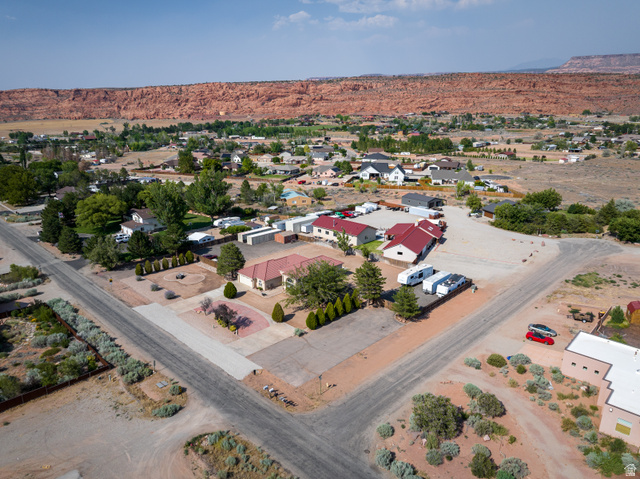 4297 Beeman Road Moab, UT 84532 - Photo 49 of 59 Aerial perspective showcasing multiple residential structures and extensive paved areas