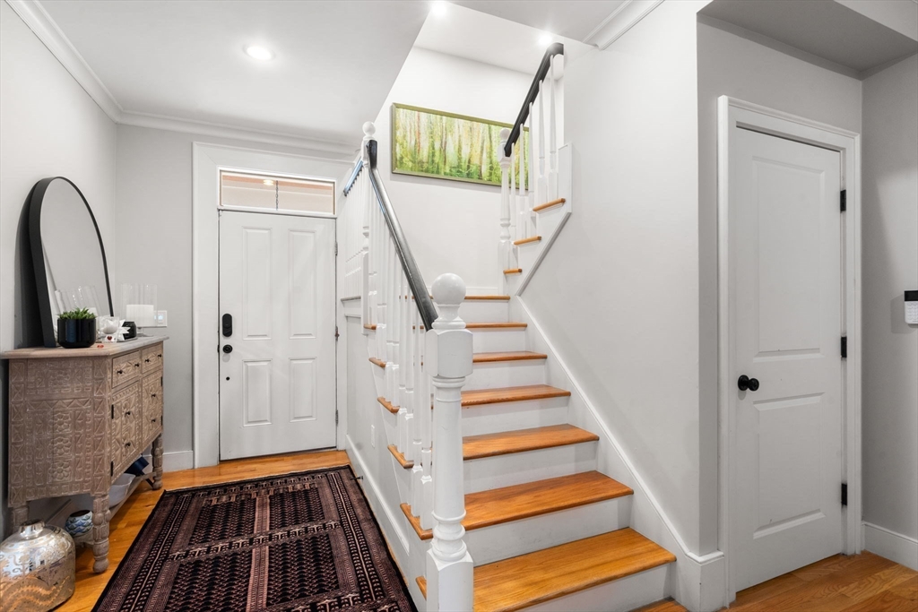 75 Auburn Street Newton, MA 02466 - Photo 11 of 34 a view of a hallway with wooden floor and staircase