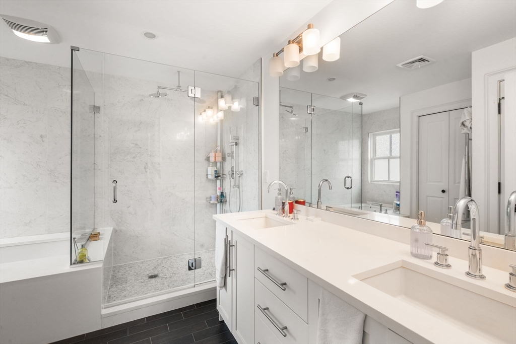 75 Auburn Street Newton, MA 02466 - Photo 15 of 34 a bathroom with a double vanity sink mirror and shower