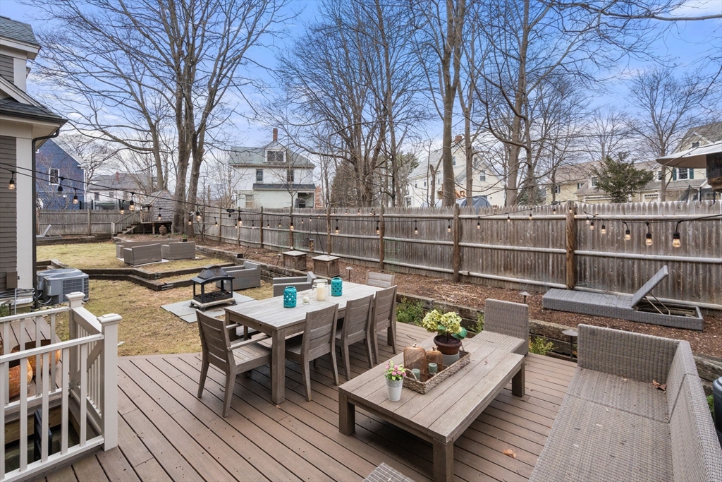 75 Auburn Street Newton, MA 02466 - Photo 32 of 34 a view of a patio with couches and dining table with wooden floor