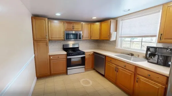 a kitchen with stainless steel appliances a stove sink and microwave