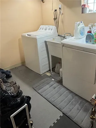 a spacious bedroom with a large bed and a chandelier