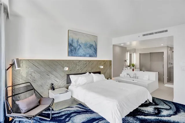 a bathroom with a tub sink mirror and a shower