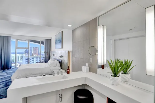 a living room with furniture and kitchen view