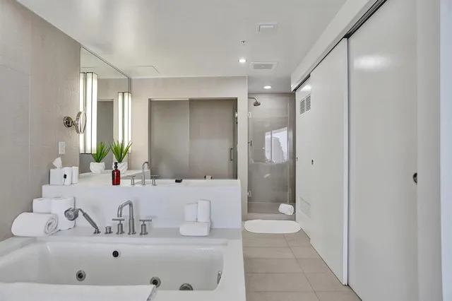 a living room with a chair and glass door