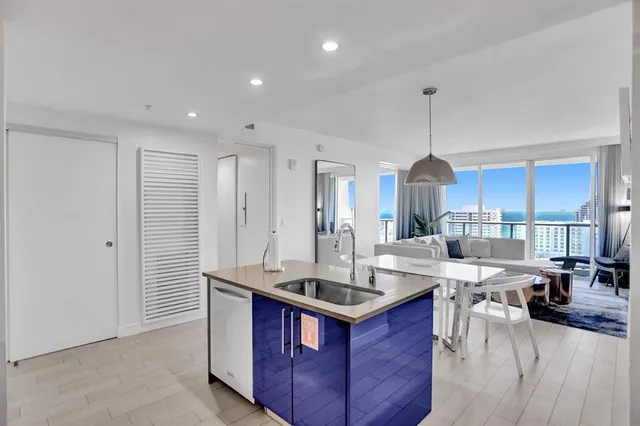 a kitchen with granite countertop a sink stove and refrigerator