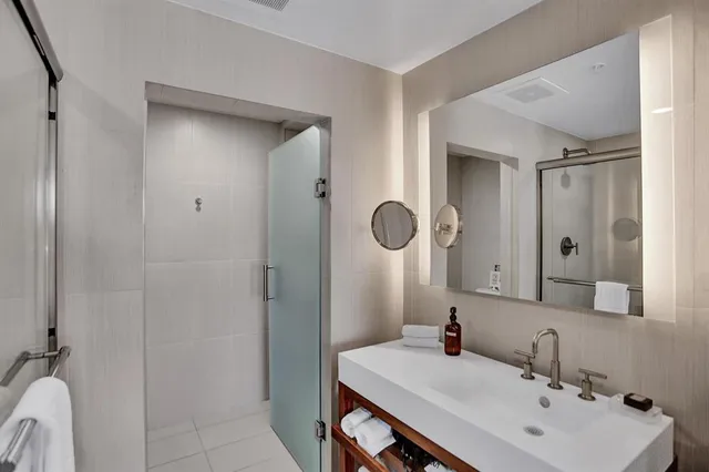 a living room with stainless steel appliances kitchen island granite countertop a dining table chairs and a kitchen view