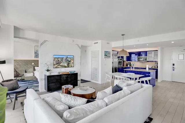 a kitchen with kitchen island a counter top space a sink stainless steel appliances and cabinets