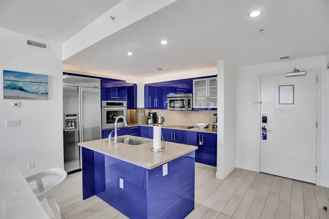 a kitchen with stainless steel appliances kitchen island granite countertop a sink stove and cabinets