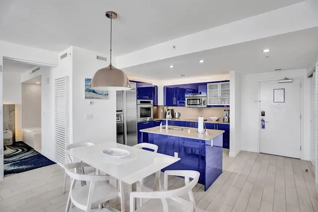 a living room with furniture a window and a chandelier