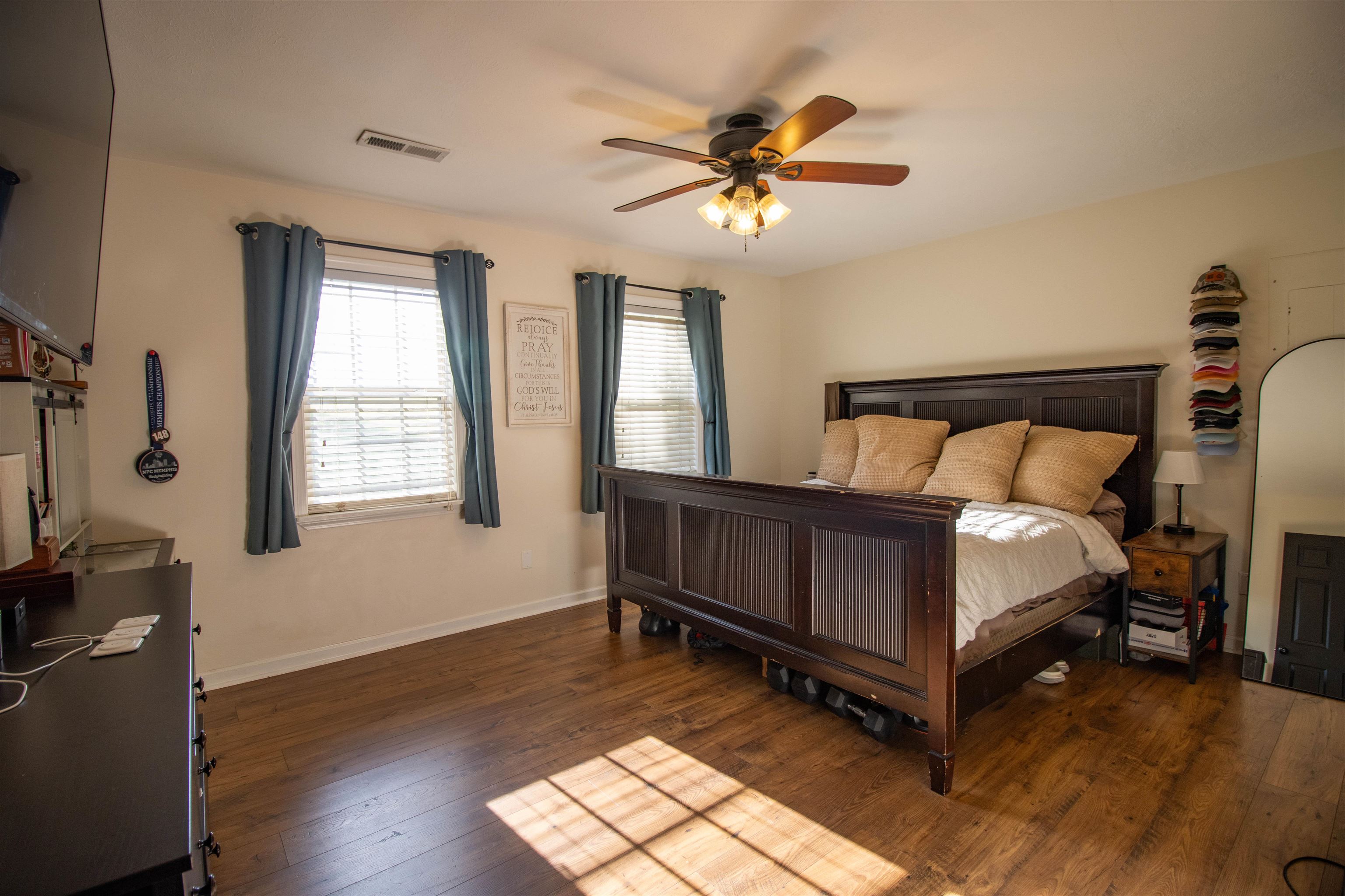 120 Craig Road Ripley, TN 38063 - Photo 15 of 38 Spacious room featuring wood-finish flooring, two windows with blinds, a ceiling fan with integrated lighting, and light-toned walls