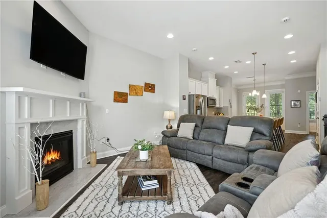 a living room with furniture a fireplace and a flat screen tv