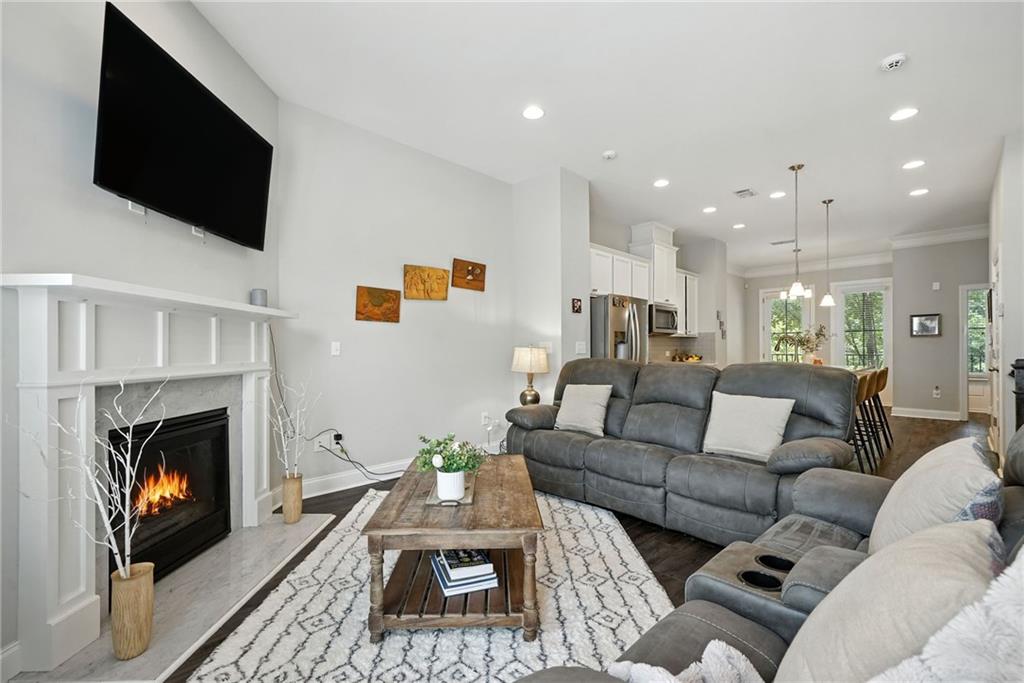 705 Bismark Road Northeast Atlanta, GA 30324 - Photo 11 of 41 a living room with furniture a fireplace and a flat screen tv