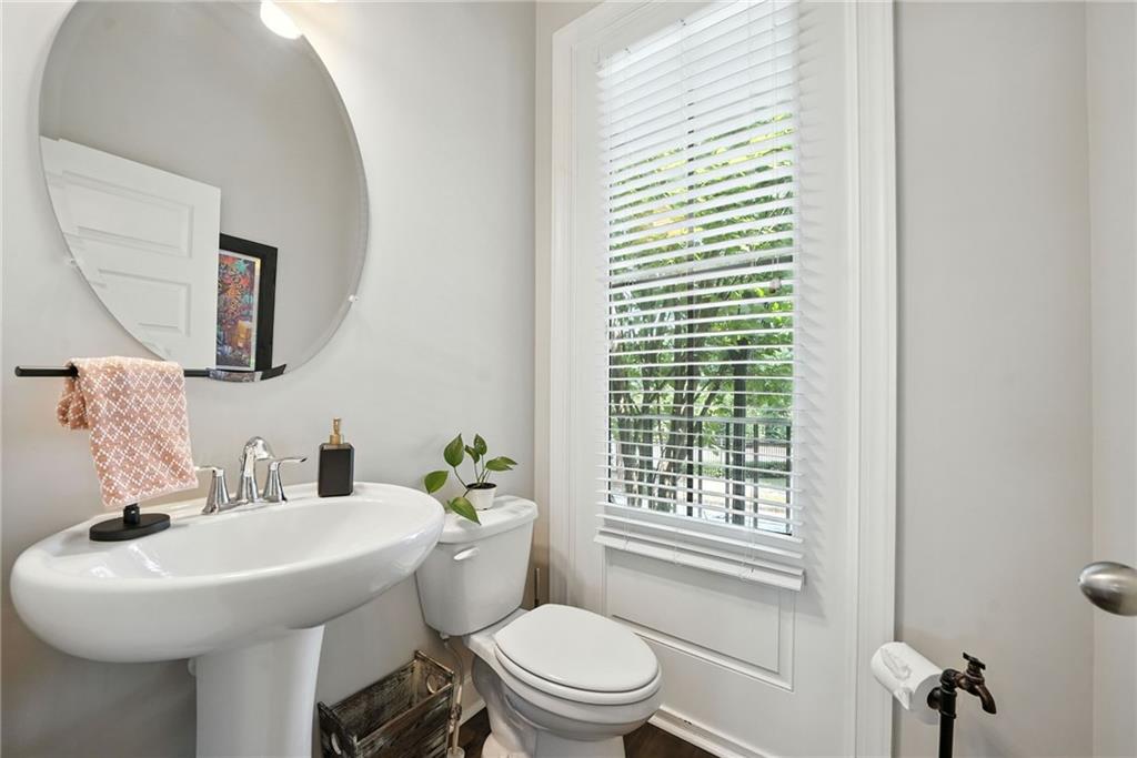705 Bismark Road Northeast Atlanta, GA 30324 - Photo 13 of 41 a bathroom with a sink a toilet and mirror