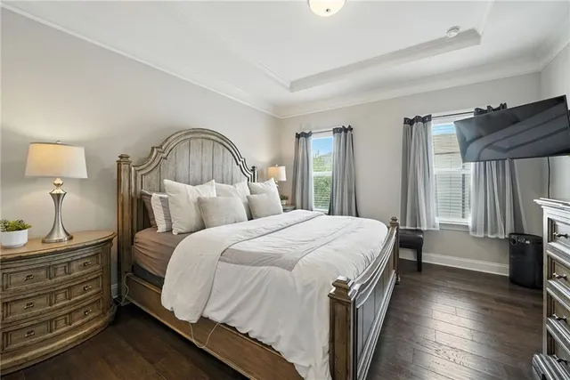 a spacious bedroom with a bed and a dresser
