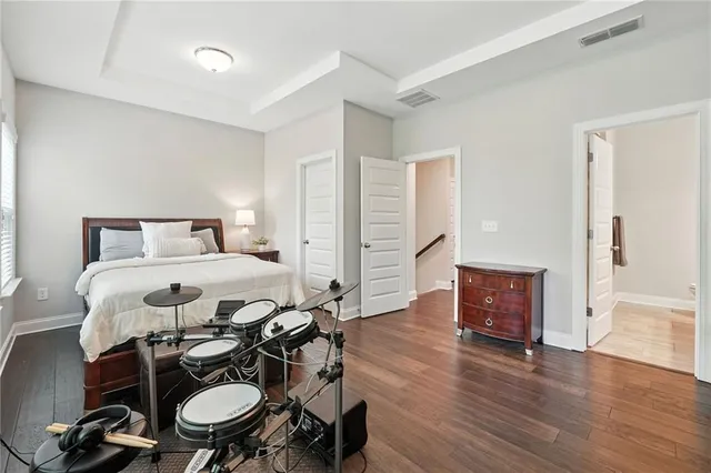 a bedroom with a bed and wooden floor