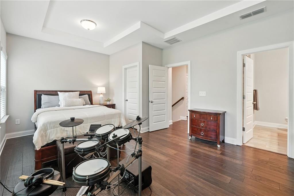 705 Bismark Road Northeast Atlanta, GA 30324 - Photo 18 of 41 a bedroom with a bed and wooden floor