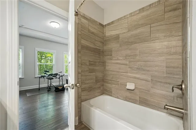 a bathroom with a bathtub and a shower
