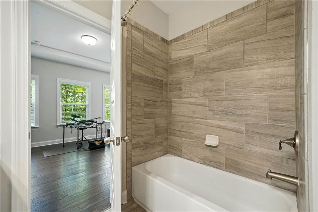 705 Bismark Road Northeast Atlanta, GA 30324 - Photo 20 of 41 a bathroom with a bathtub and a shower