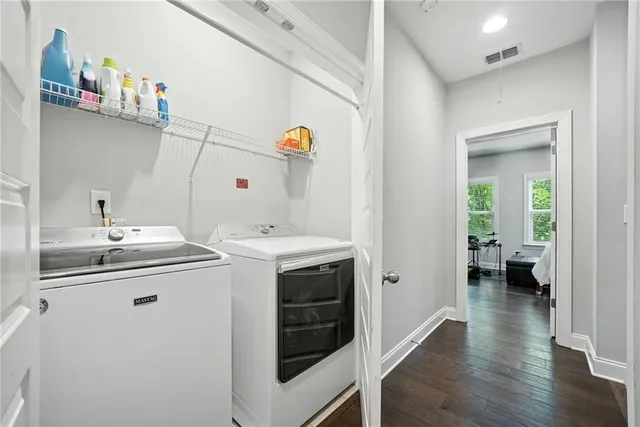 a utility room with cabinets and washer