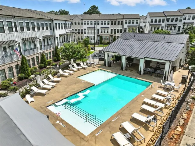 a view of a house with pool and sitting area