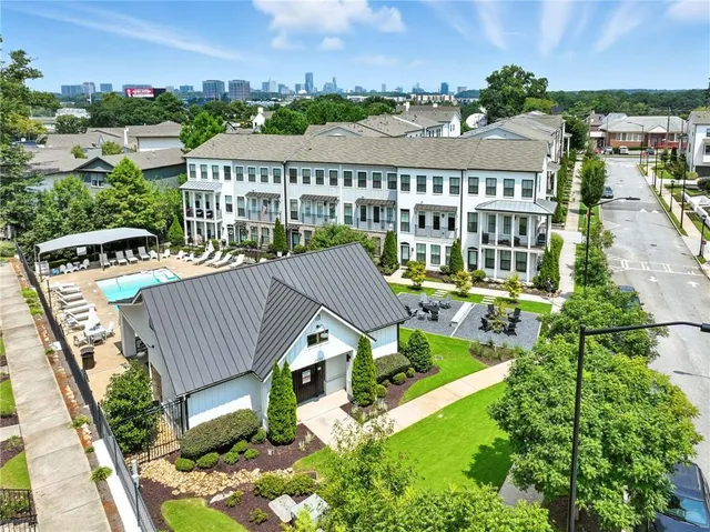 an aerial view of a house with swimming pool outdoor seating and yard