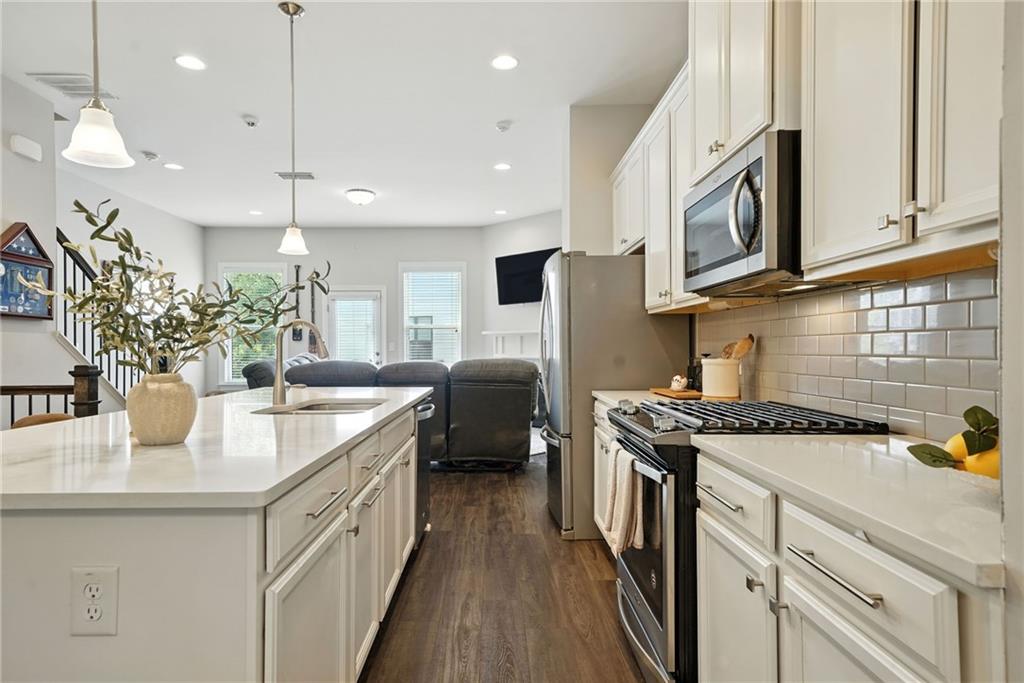705 Bismark Road Northeast Atlanta, GA 30324 - Photo 5 of 41 a kitchen with stainless steel appliances granite countertop a sink a stove and a wooden floors