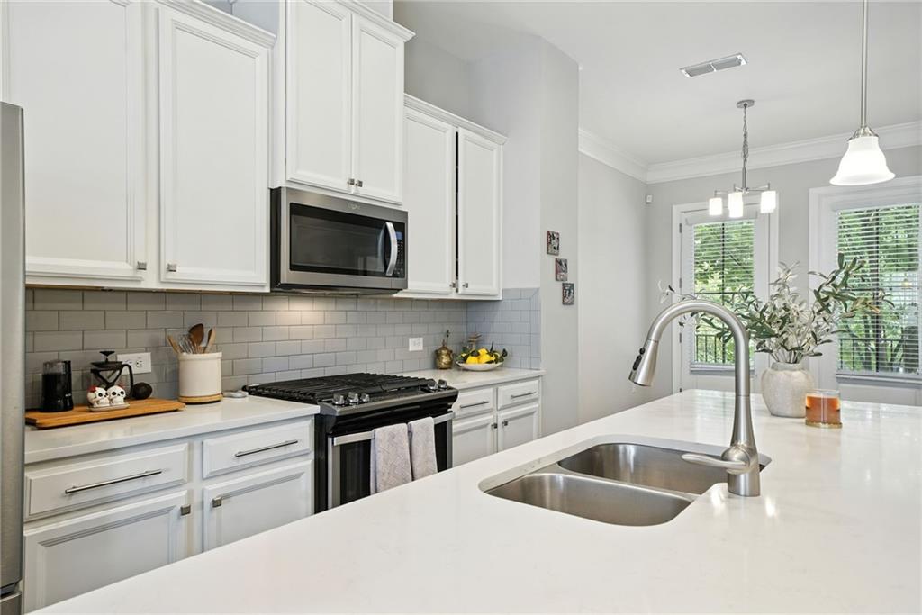 705 Bismark Road Northeast Atlanta, GA 30324 - Photo 6 of 41 a kitchen with granite countertop a sink a stove and cabinets