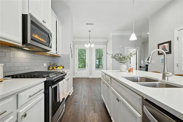 a kitchen with a sink stove and microwave