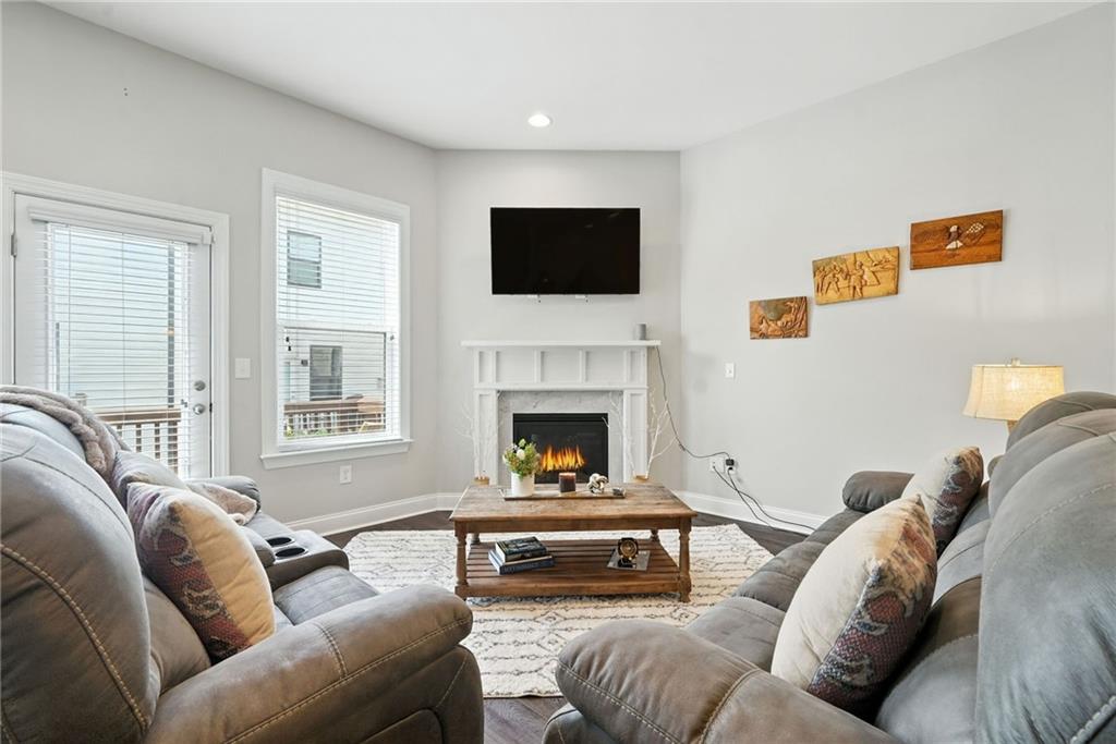 705 Bismark Road Northeast Atlanta, GA 30324 - Photo 10 of 41 a living room with furniture a flat screen tv and a fireplace