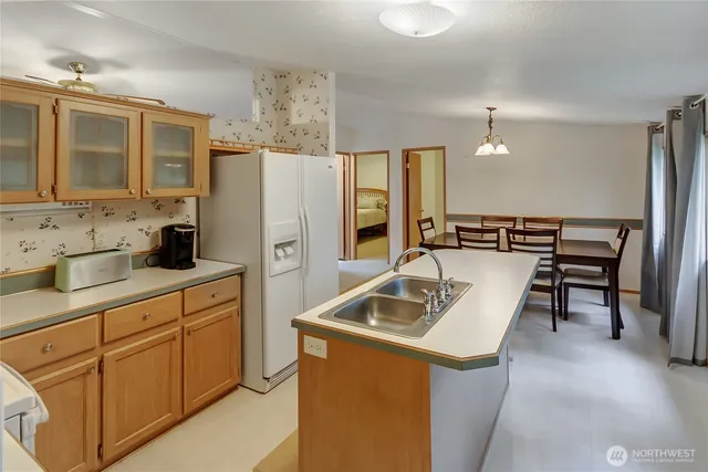 a kitchen that has a sink a stove and a microwave