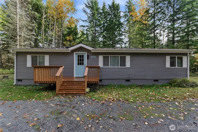 a view of a house with a yard and wooden fence