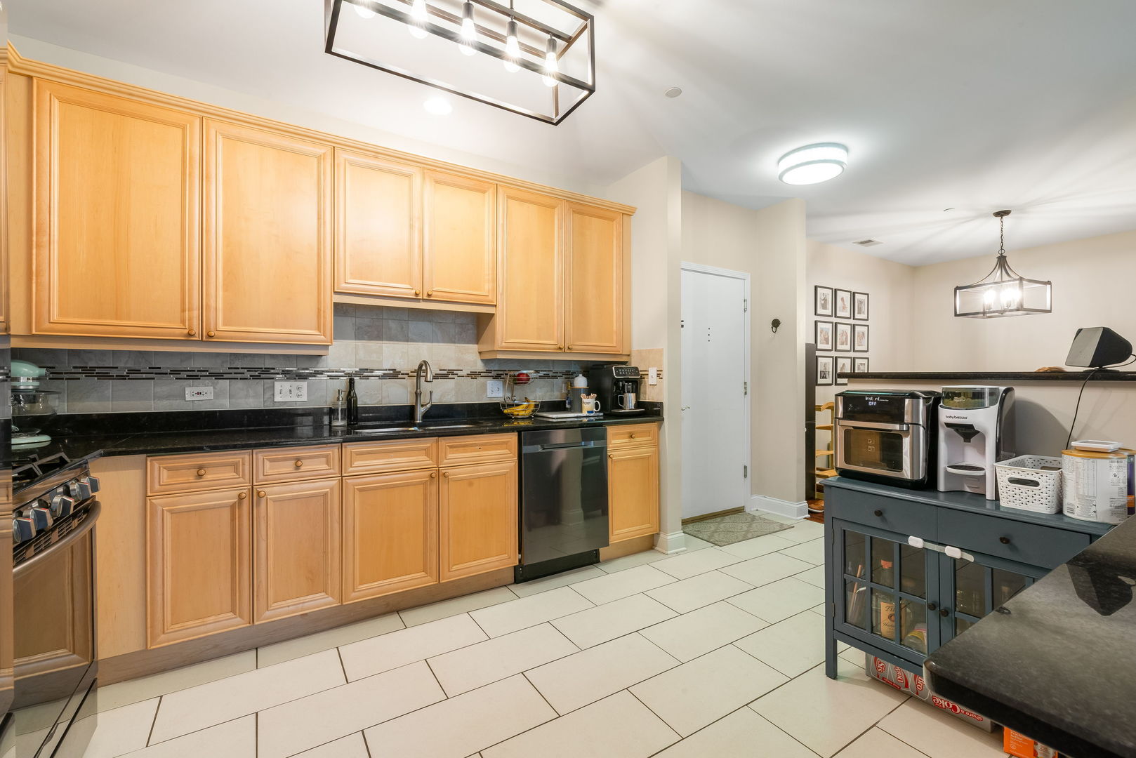 620 McHenry Road, Unit 102 Wheeling, IL 60090 - Photo 11 of 18 a kitchen with stainless steel appliances granite countertop a stove a sink and a refrigerator