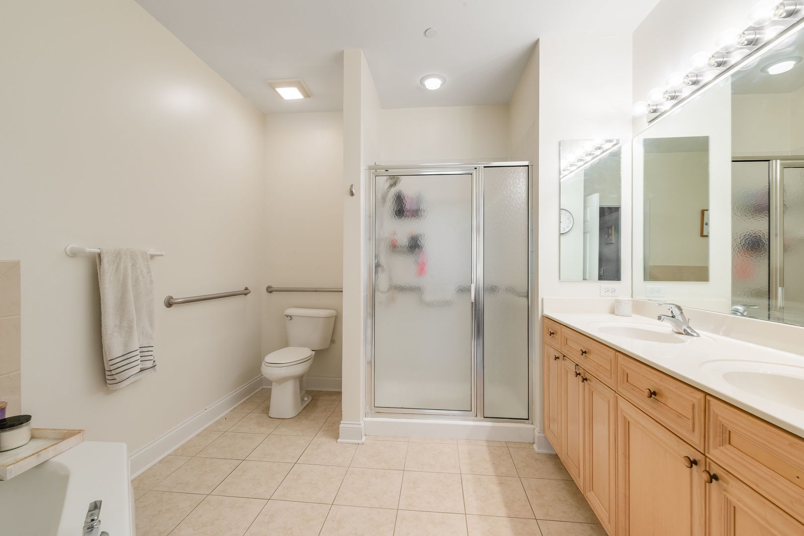 620 McHenry Road, Unit 102 Wheeling, IL 60090 - Photo 14 of 18 a spacious bathroom with a granite countertop sink toilet and shower