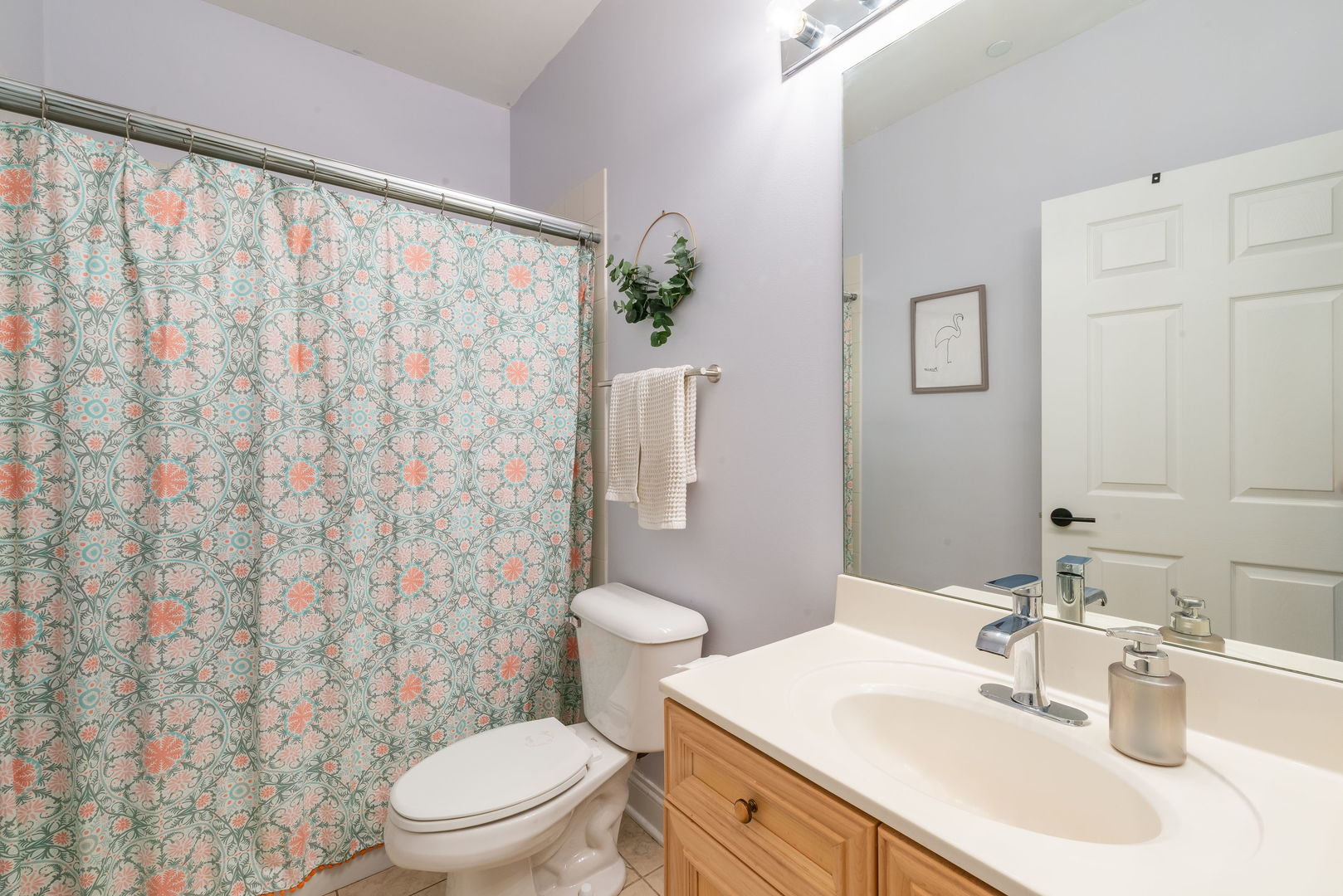 620 McHenry Road, Unit 102 Wheeling, IL 60090 - Photo 17 of 18 a bathroom with a sink a toilet and shower curtain