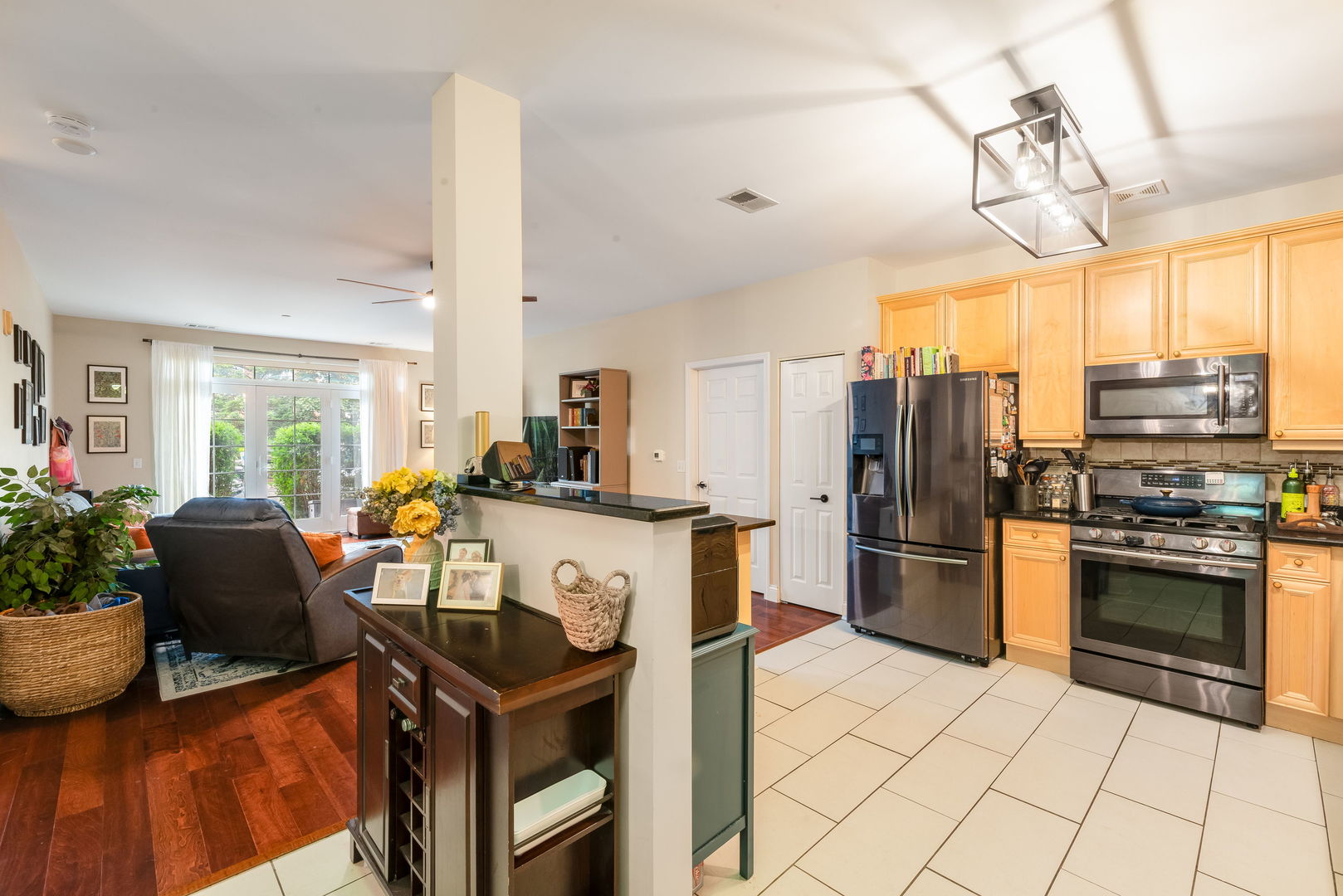 620 McHenry Road, Unit 102 Wheeling, IL 60090 - Photo 9 of 18 a kitchen with stainless steel appliances granite countertop a stove refrigerator and a dining table with wooden floor