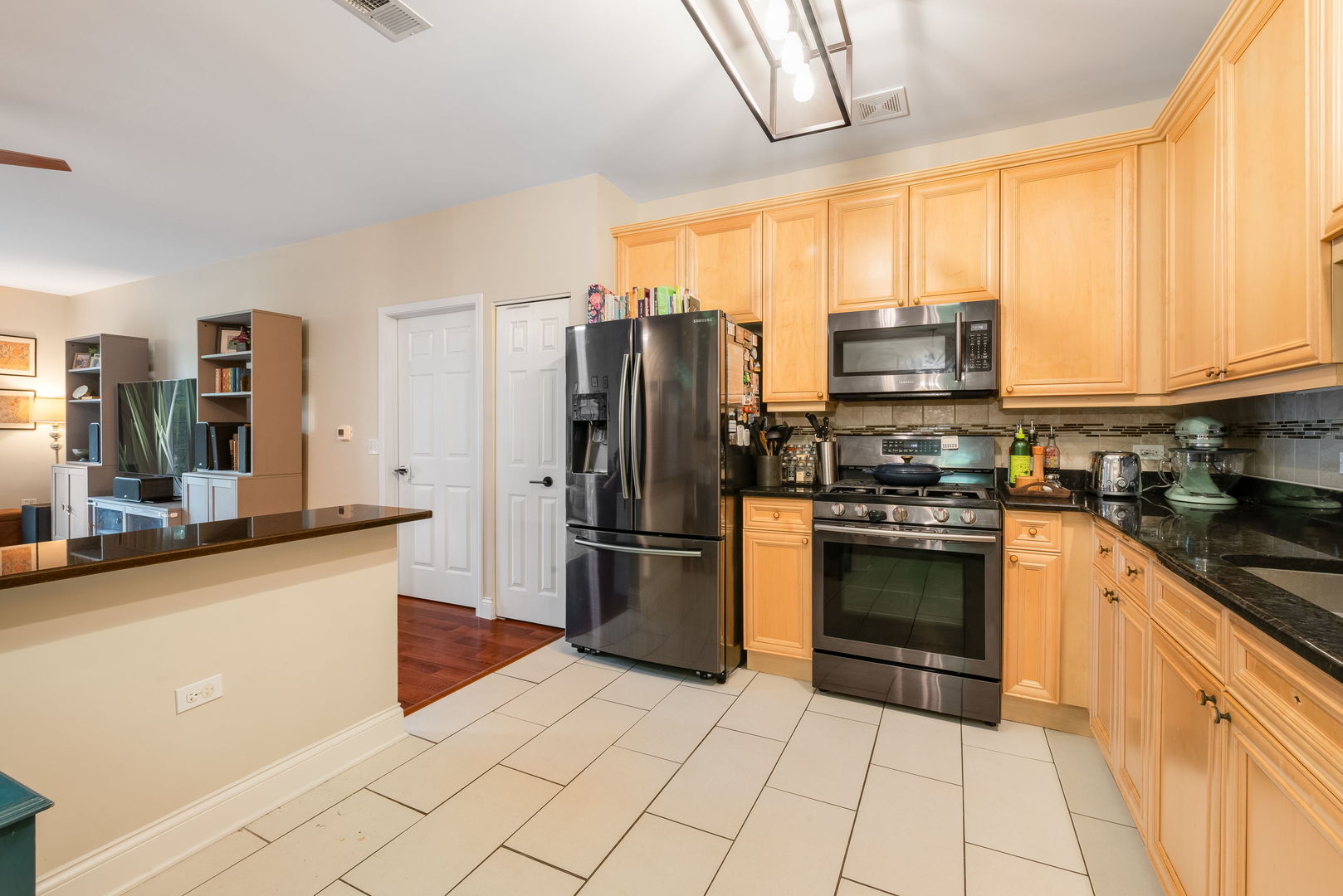 620 McHenry Road, Unit 102 Wheeling, IL 60090 - Photo 10 of 18 a kitchen with stainless steel appliances a refrigerator sink and microwave