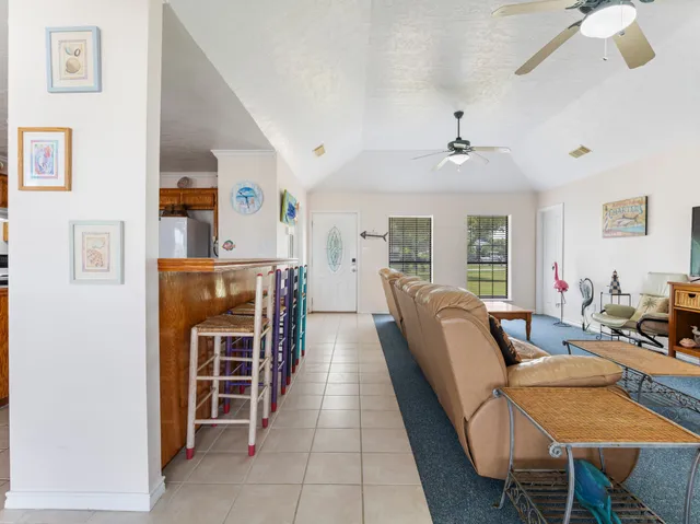 a living room with furniture a dining table and chairs with wooden floor