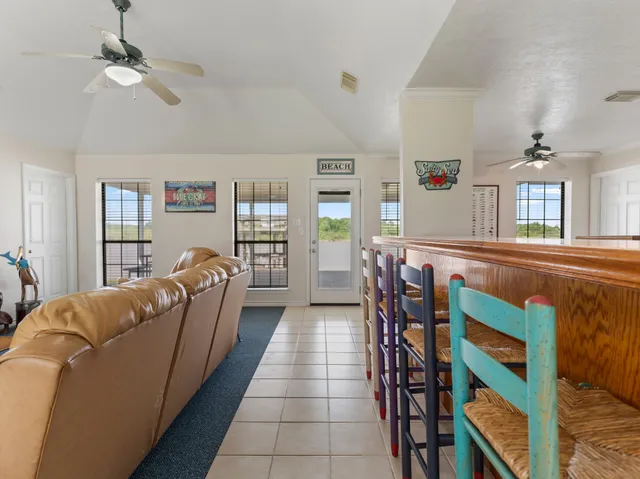 a living room with furniture and a dining table
