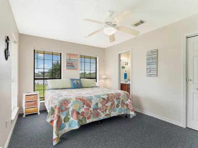 a bedroom with a bed lamp and a window