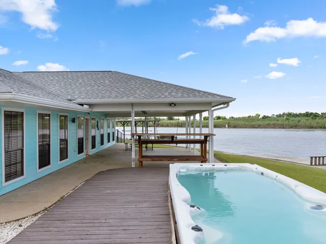 a swimming pool with outdoor seating and yard