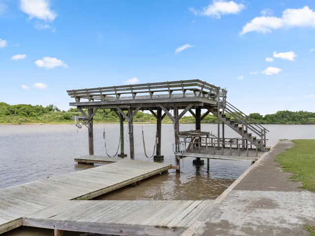 a view of a swimming pool with seating area and lake view