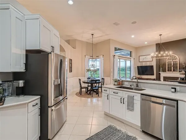 a kitchen with stainless steel appliances a sink stove refrigerator and cabinets