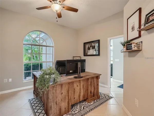 a living room with furniture a fireplace and a large window