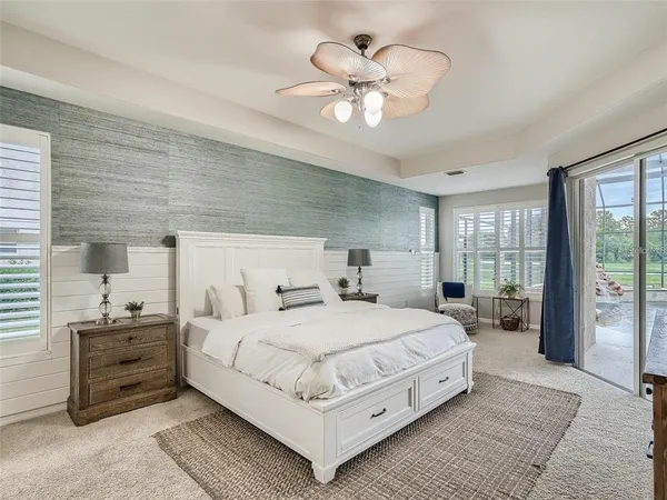 a bedroom with a large bed and a chandelier