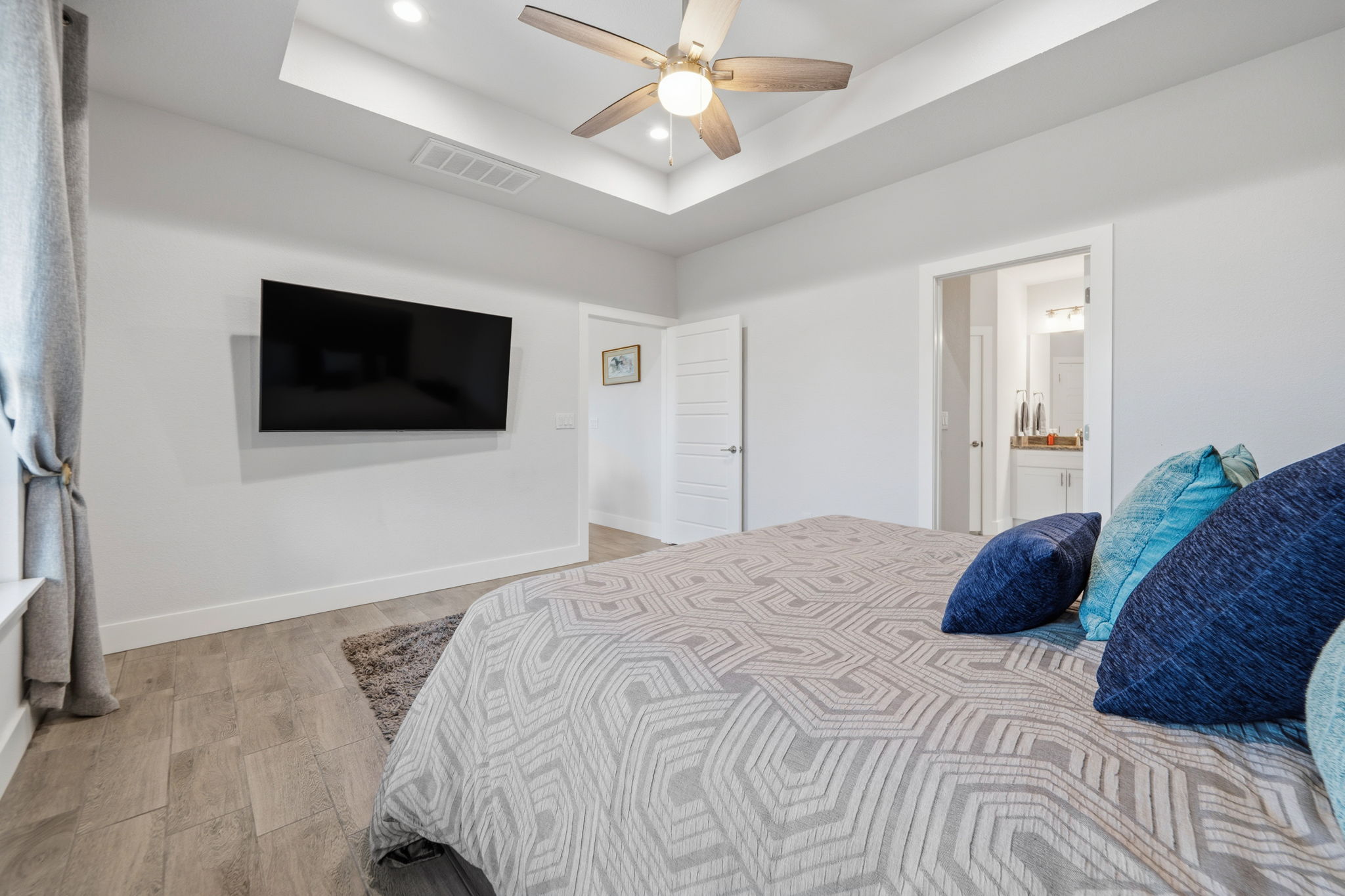 18605 Masters Cove Point Venture, TX 78645 - Photo 18 of 40 Room featuring a tray ceiling with recessed lighting and a ceiling fan