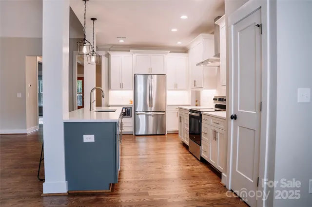 a kitchen with stainless steel appliances a refrigerator and a stove