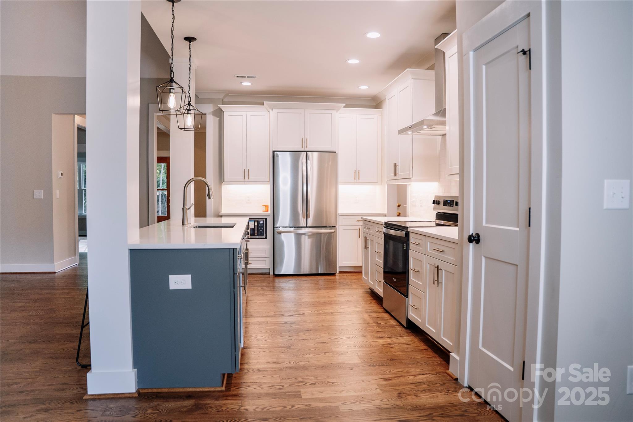 1004 East Sandy Ridge Road Monroe, NC 28112 - Photo 12 of 25 a kitchen with stainless steel appliances a refrigerator and a stove