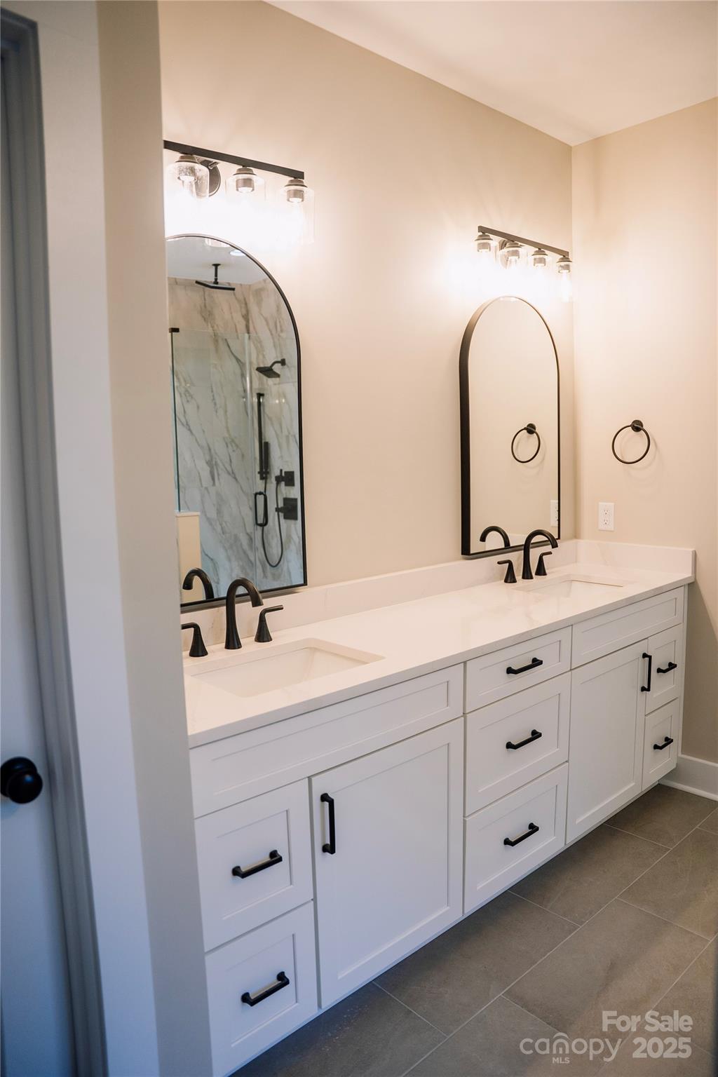 1004 East Sandy Ridge Road Monroe, NC 28112 - Photo 18 of 25 a bathroom with a double vanity sink and a mirror