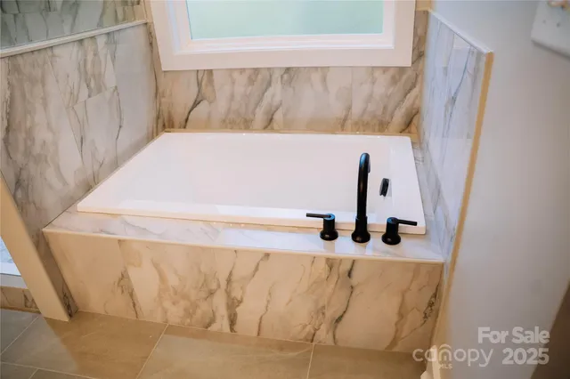 a bathroom with a sink and a window